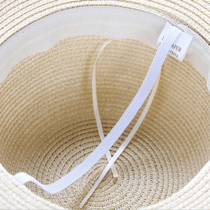 Interior of foldable straw sun hat showing sweatband and elastic for comfort fit