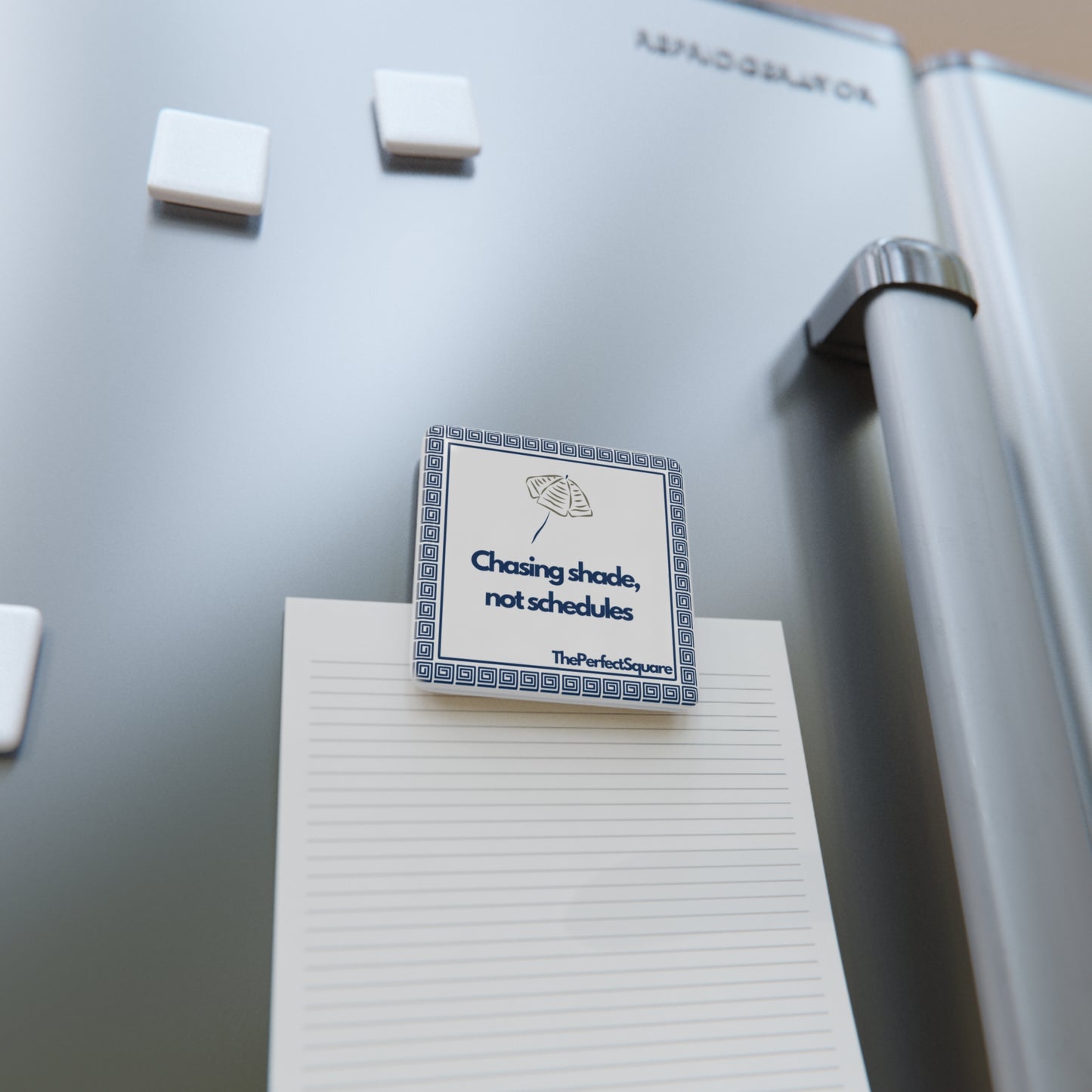 Porcelain quote magnet on a refrigerator – minimalist and motivational home décor