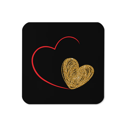 Square coaster with a cork backing, with a red and gold heart print on a black coaster