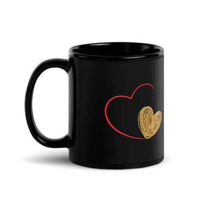 A black ceramic mug with a minimalist design featuring a red heart and a gold-colored heart.