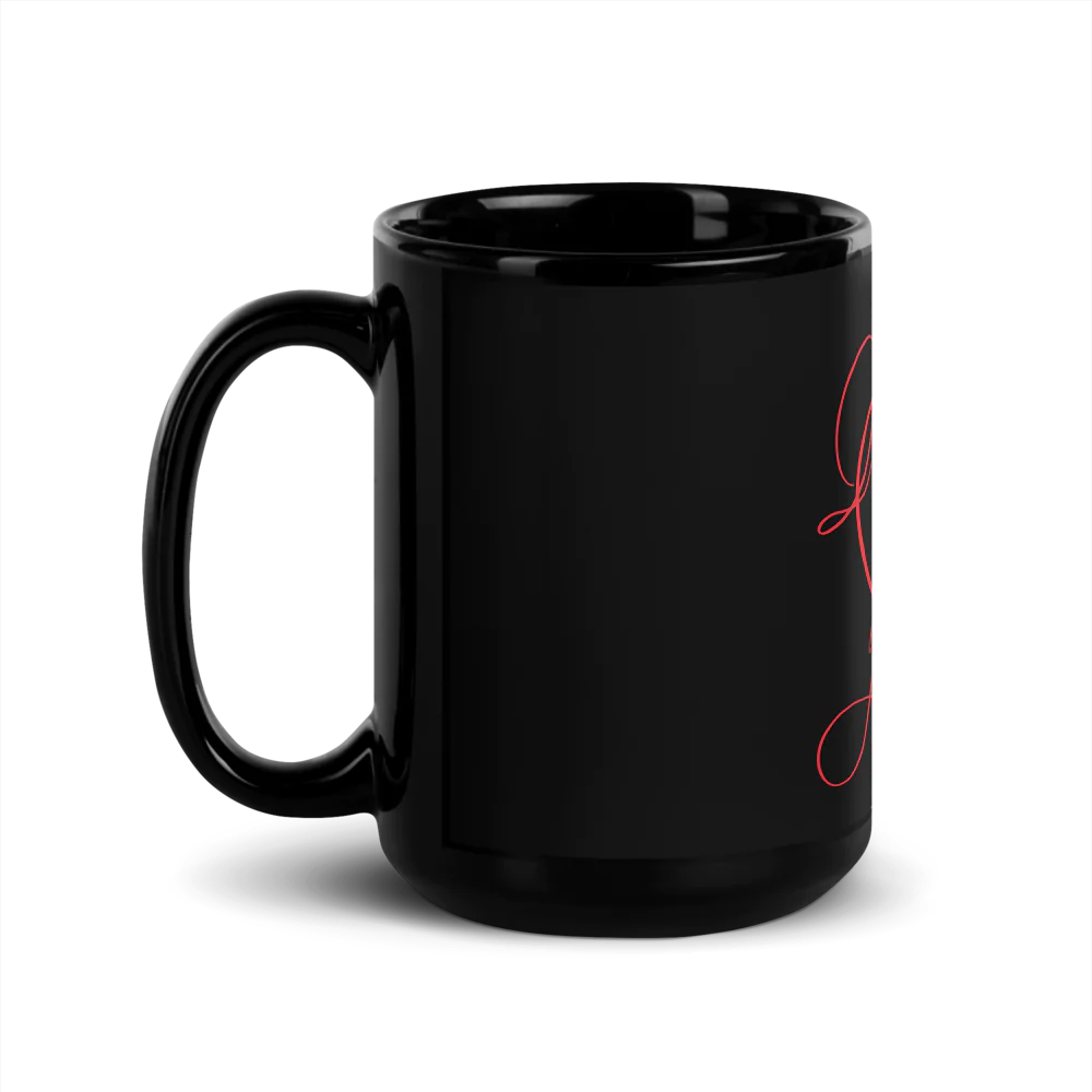 A black ceramic mug with a minimalist design featuring a red heart and a gold-colored heart.