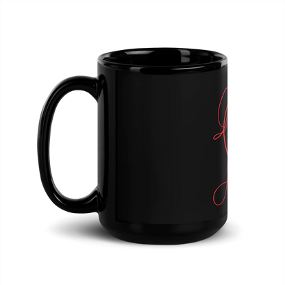 A black ceramic mug with a minimalist design featuring a red heart and a gold-colored heart.