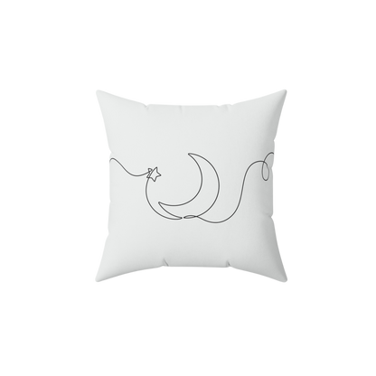 White pillow with black crescent moon and star design 
