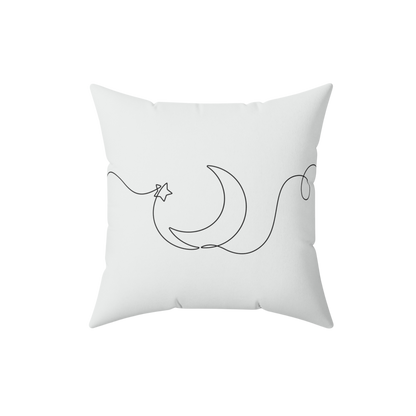 White pillow with black crescent moon and star design