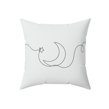 White pillow with black crescent moon and star design 