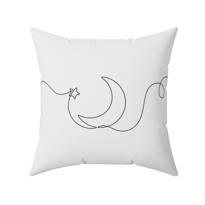 White pillow with black line art design of a crescent moon and star