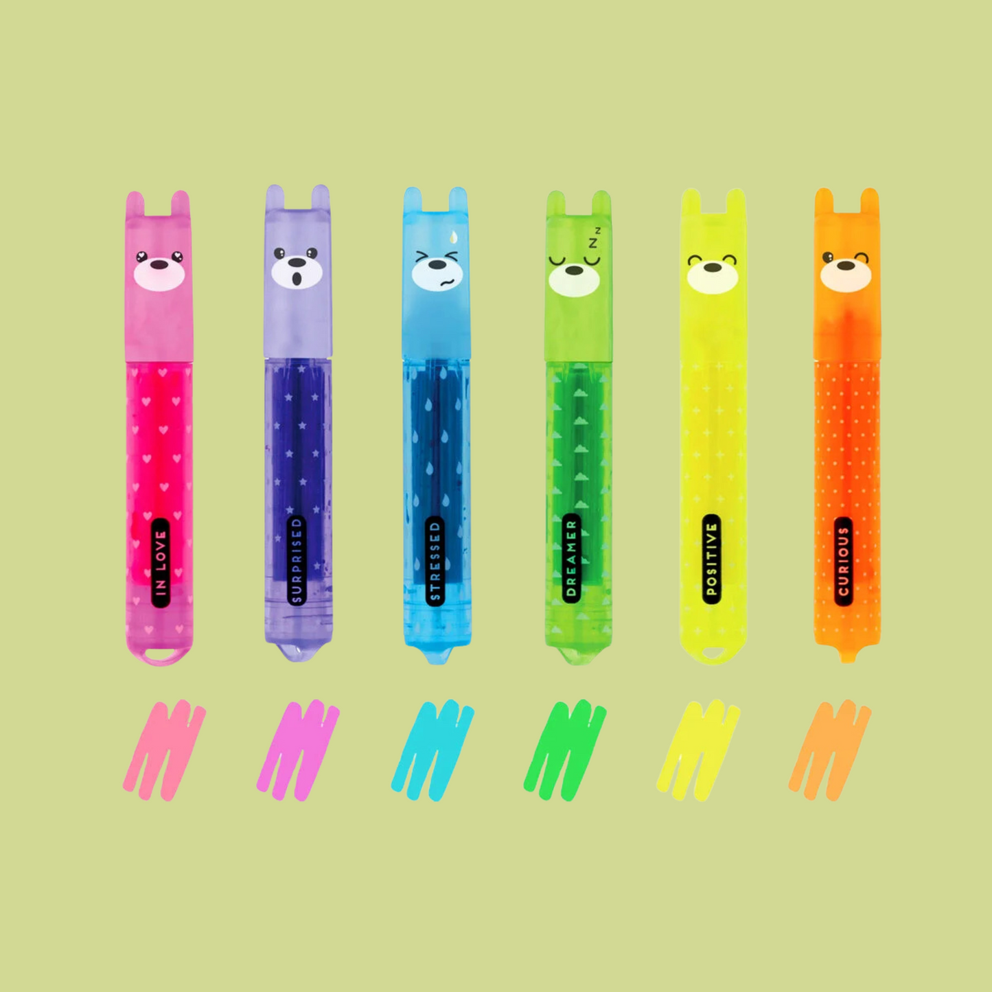 Set of colorful highlighters with bear faces on a green background