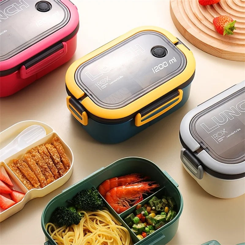 White, blue, and pink lunch boxes closed with green lunchbox and middle layer showing