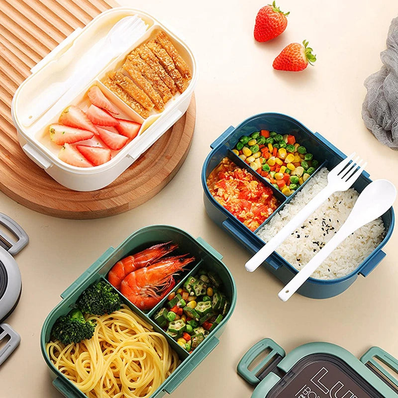 White, green, and blue lunch boxes open with food, fork, and spoon inside