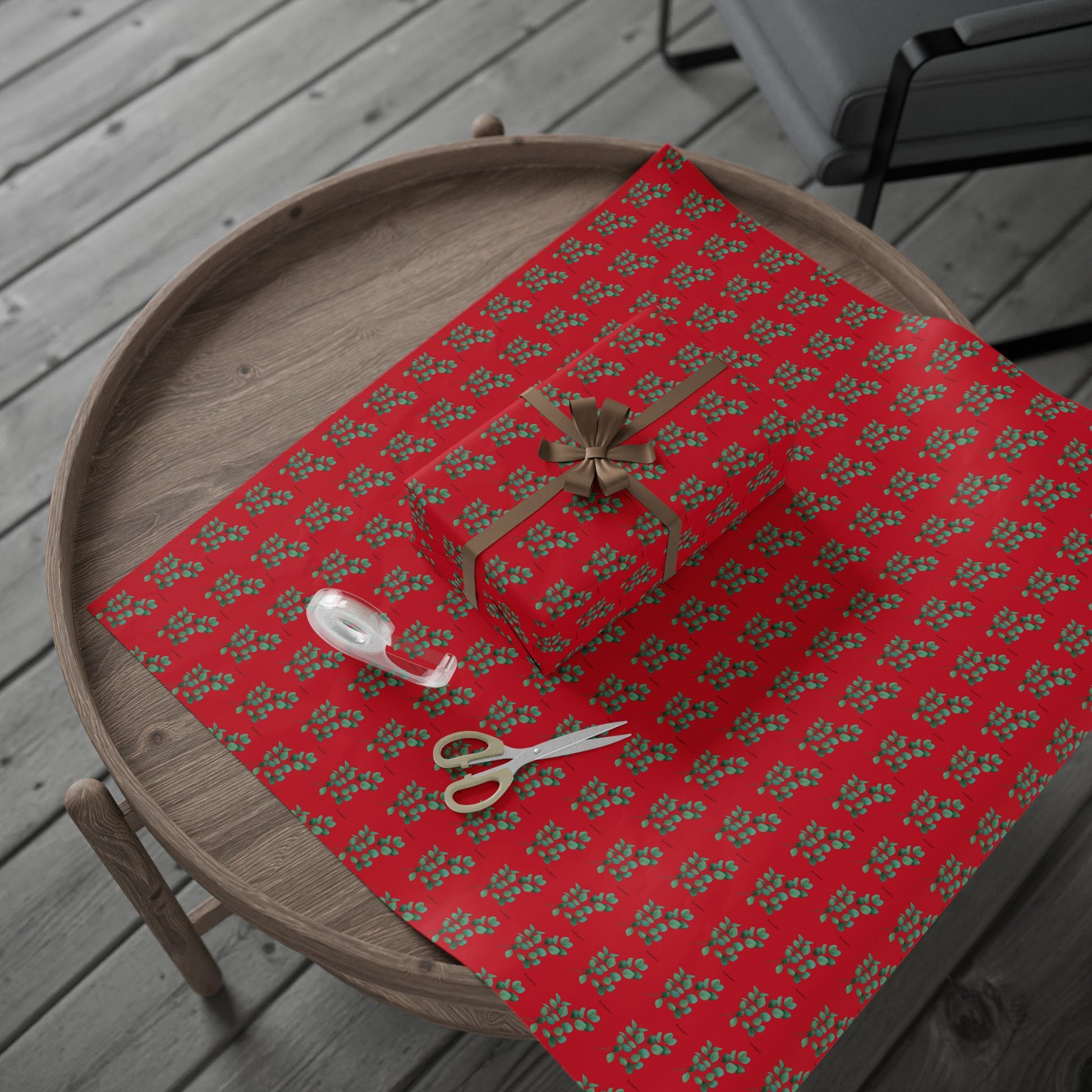 Single sheet of eucalyptus wrapping paper with wrapped present, scissors, and sellotape