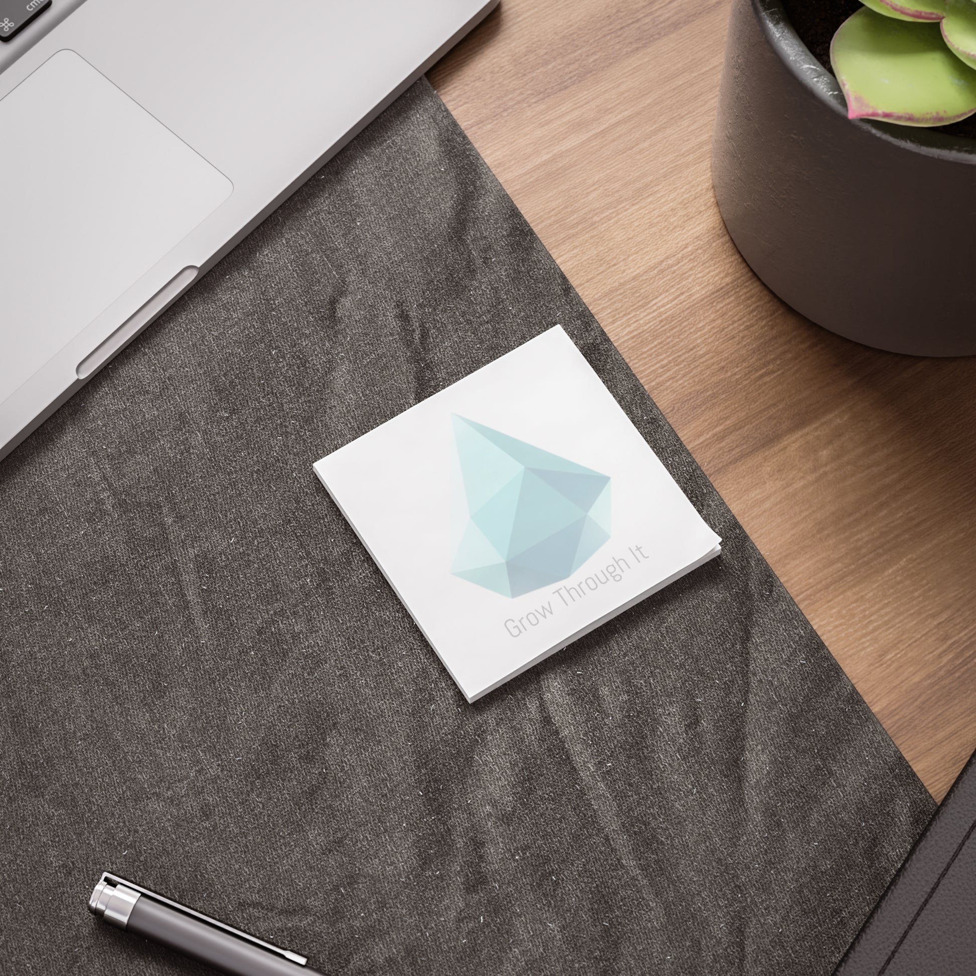 Drop gem Post-it pad on desk beside laptop and pen