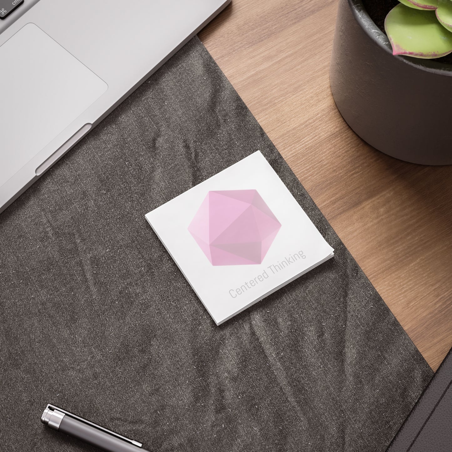 Hexagon gem Post-it pad on desk beside laptop and pen