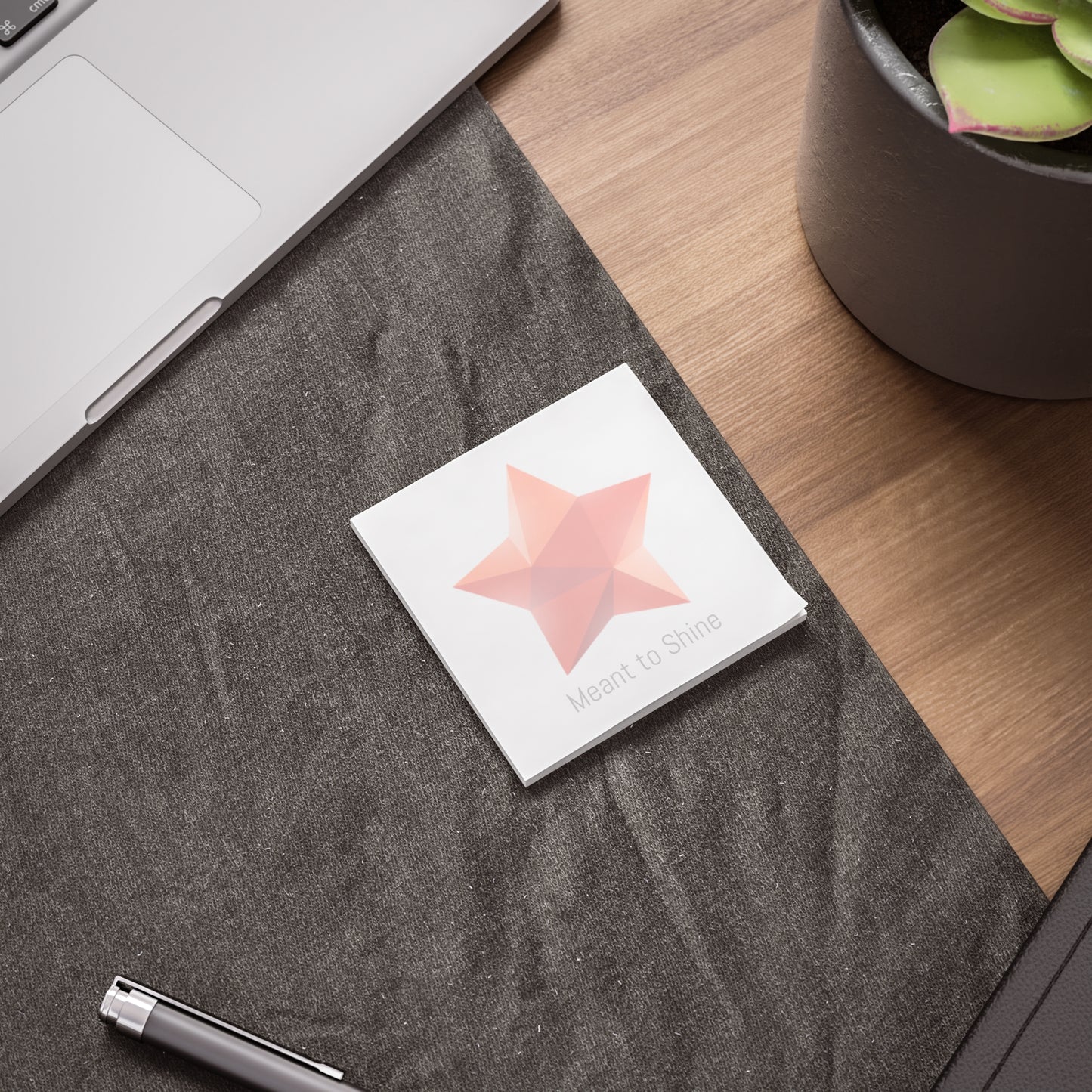 Star gem Post-it pad on desk beside laptop and pen